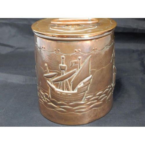 494 - An Arts & Crafts Newlyn oval tea caddy, the cover with swing handle and applied strapwork decorated ... 