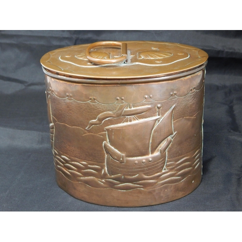 494 - An Arts & Crafts Newlyn oval tea caddy, the cover with swing handle and applied strapwork decorated ... 