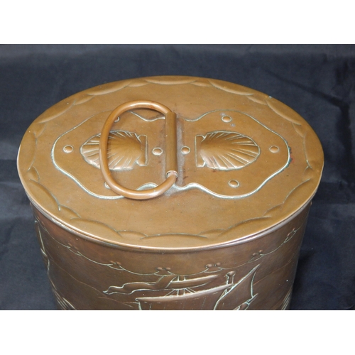 494 - An Arts & Crafts Newlyn oval tea caddy, the cover with swing handle and applied strapwork decorated ... 