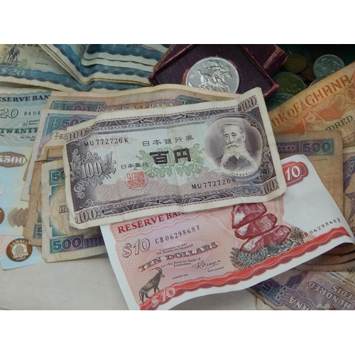 87A - A Quantity of World Banknotes & Coins contained in a bag.