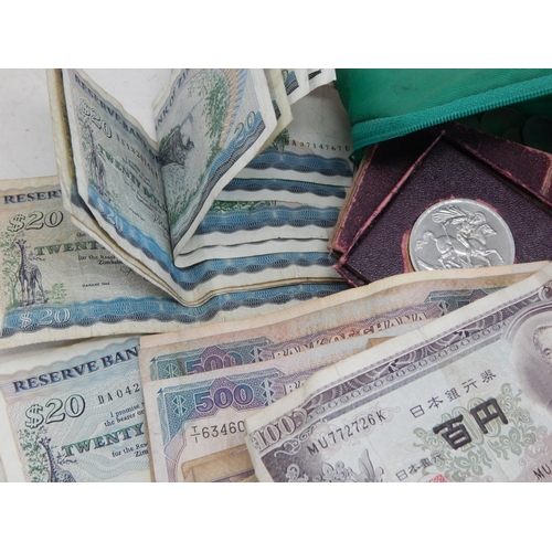 87A - A Quantity of World Banknotes & Coins contained in a bag.