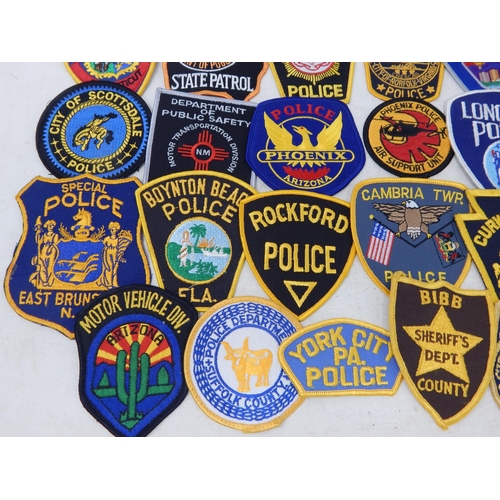 569 - A Collection of 25 Cloth USA Police Badges from a private collection