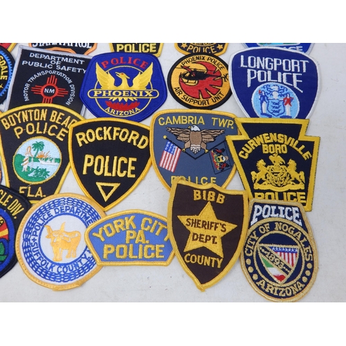 569 - A Collection of 25 Cloth USA Police Badges from a private collection