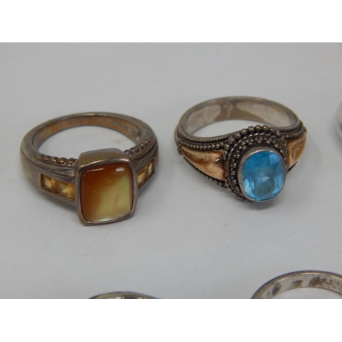 411 - A Collection of 8 Sterling Silver Rings.