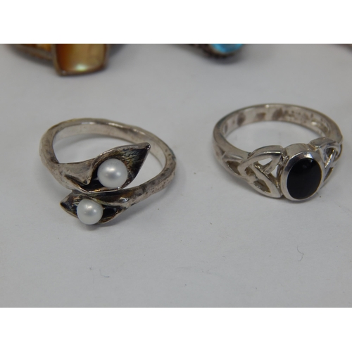 411 - A Collection of 8 Sterling Silver Rings.