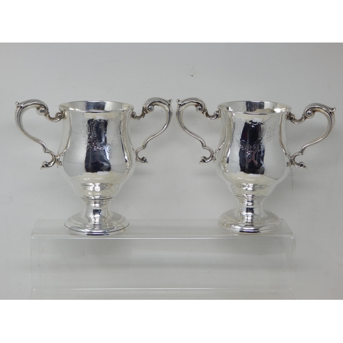 106 - A PAIR OF GEORGE III IRISH SILVER TWO-HANDLED CUPS by Matthew West, Dublin, c.1770, of plain form wi... 