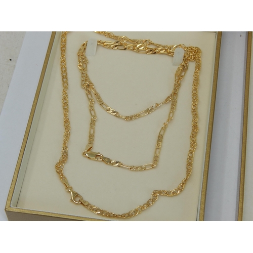 425 - A Collection of Four Sterling Silver & Gilded Neck Chains within Two Presentation Cases