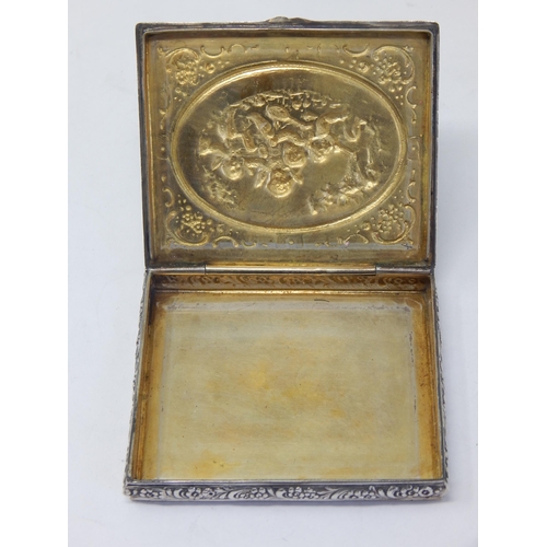 112 - An 800 Standard Silver Case with Gilded Interior: The cover with an embossed scene of putti playing ... 