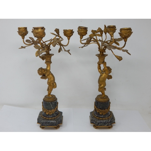 582 - A Pair of 19th Century French Ormolu Bronze Candelabra with Winged Putti each holding aloft a vase c... 