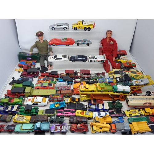 589 - Two 1970's Action Men (One being the bionic man) together with a large quantity of playworn model ve... 