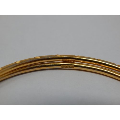 296 - A Pair of Indian 22ct Gold Bangles: Internal Diameter 60mm: Weight 20.59g