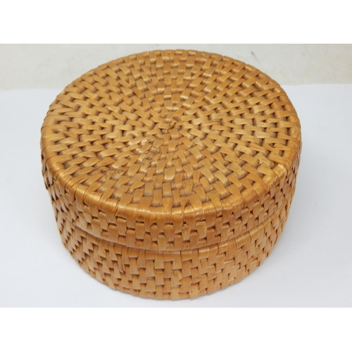 543A - A Set of 6 drinks coasters depicting erotic scenes contained in a rattan basket.