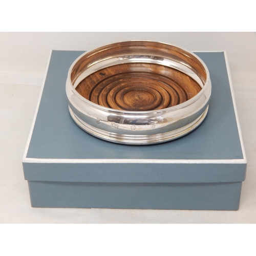 716 - Silver Bottle Coaster with Turned Wooden Base: Hallmarked London 1976 by A Chick & Sons Ltd in Origi... 