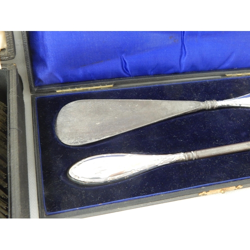 795 - A Cased Pair of Hallmarked Silver Hair Brushes together with a Cased Silver Handled Shoe Horn & Butt... 