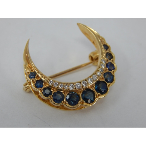 839 - Unmarked Gold Diamond & Sapphire Set Crescent Brooch: Width 2.4cm: Gross weight 3.61g