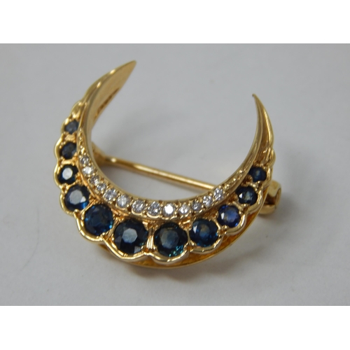 839 - Unmarked Gold Diamond & Sapphire Set Crescent Brooch: Width 2.4cm: Gross weight 3.61g