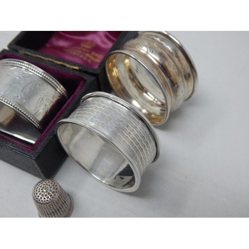 115 - 3 x Hallmarked Silver Napkin Rings together with a Hallmarked Silver Thimble by Charles Horner: Vari... 