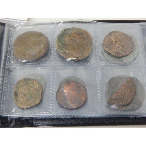 92 - A Large Quantity of Roman & Ancient Coins contained in two coin albums together with reference books... 