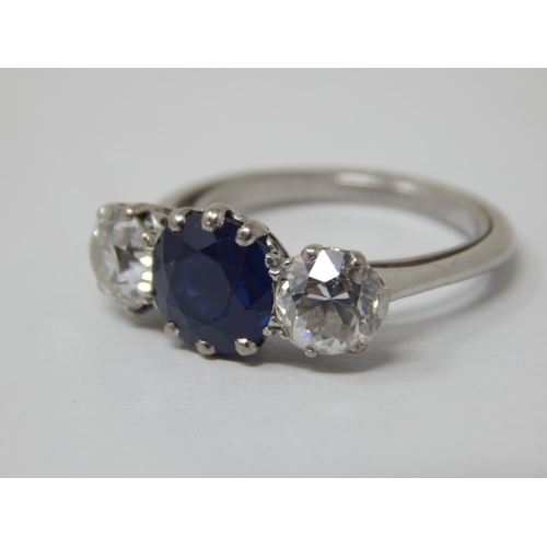 132 - Platinum Set Diamond & Sapphire Ring: The Central Sapphire estimated @ 1.50cts between Two Diamonds ... 