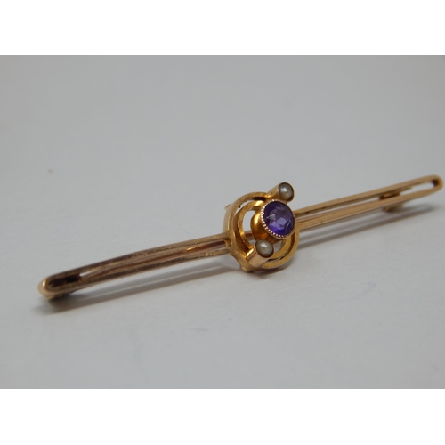 142 - Edwardian 15ct Gold Bar Brooch Set with an Amethyst & Seed Pearls: Length 5cm: gross weight 2.6g