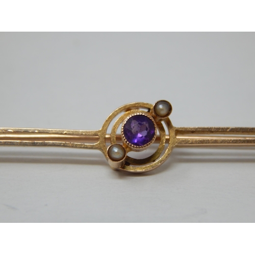 142 - Edwardian 15ct Gold Bar Brooch Set with an Amethyst & Seed Pearls: Length 5cm: gross weight 2.6g