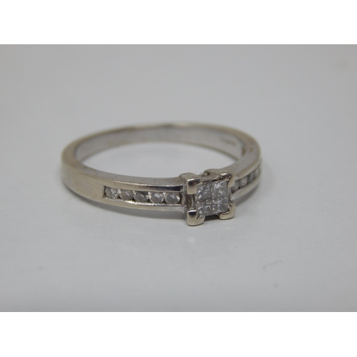 158 - 9ct White Gold Diamond Ring with a Central Panel Containing Four Princess Cut Diamonds: The Shoulder... 