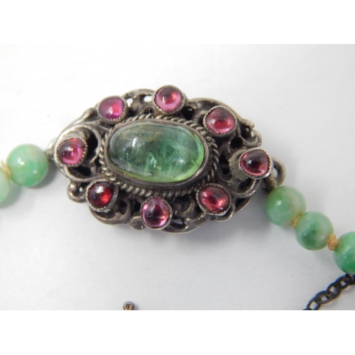 169 - Early 20th Century Graduated Jade Bead Necklace with a White Metal Clasp Set with a Central Polished... 