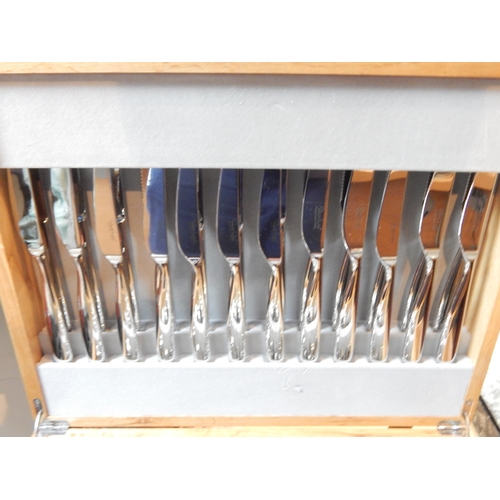 263 - Robert Welch (1929-2000): Full Canteen of Cutlery for 8 Place Settings with Servers (unused) in wood... 