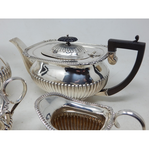 112A - George V Silver Four Piece Tea Service Comprising: Teapot, Hot Water Pot, Sugar Bowl & Milk Jug with... 