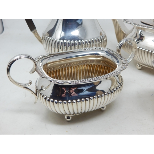 112A - George V Silver Four Piece Tea Service Comprising: Teapot, Hot Water Pot, Sugar Bowl & Milk Jug with... 