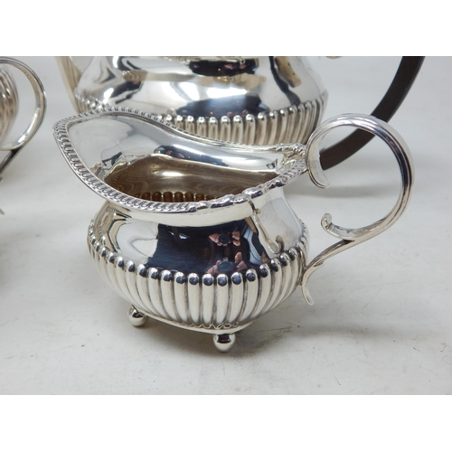 112A - George V Silver Four Piece Tea Service Comprising: Teapot, Hot Water Pot, Sugar Bowl & Milk Jug with... 