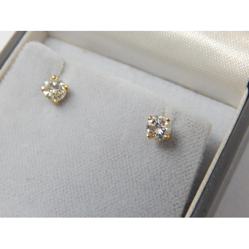 118 - A Pair of 18ct Gold Diamond Solitaire Earrings: The Diamonds of Good Colour & Clarity estimated @ 0.... 