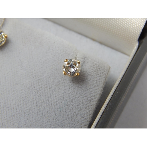 118 - A Pair of 18ct Gold Diamond Solitaire Earrings: The Diamonds of Good Colour & Clarity estimated @ 0.... 