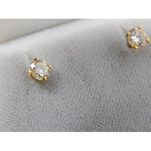 118 - A Pair of 18ct Gold Diamond Solitaire Earrings: The Diamonds of Good Colour & Clarity estimated @ 0.... 