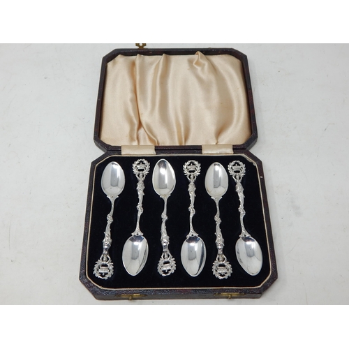 131 - A Set of 6 Victorian Silver Tea Spoons with Cast Silver Handles depicting Figures holding aloft a cr... 