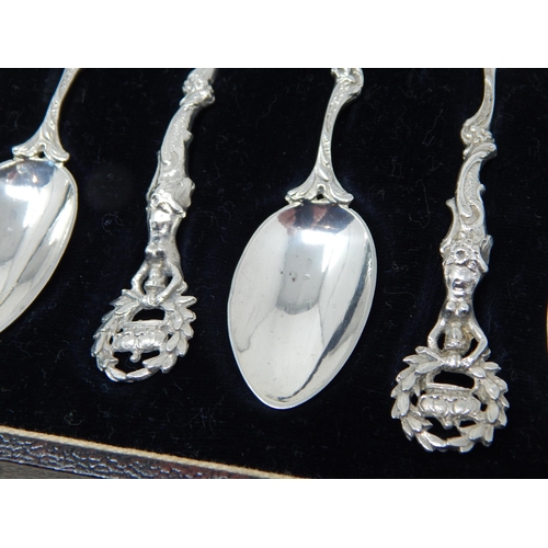 131 - A Set of 6 Victorian Silver Tea Spoons with Cast Silver Handles depicting Figures holding aloft a cr... 