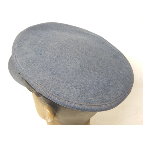 417 - A WWII RAF officers cap, blue cloth with G.A Dunn & Co tailor label, king's crown cloth insignia wit... 