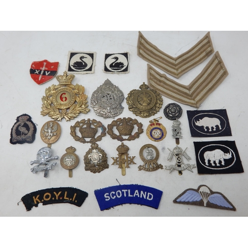 441 - A Quantity of Military Brass & White Metal Badges together with cloth badges & insignia.