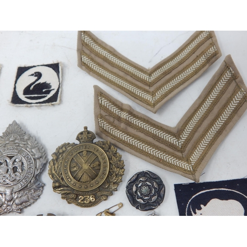 441 - A Quantity of Military Brass & White Metal Badges together with cloth badges & insignia.