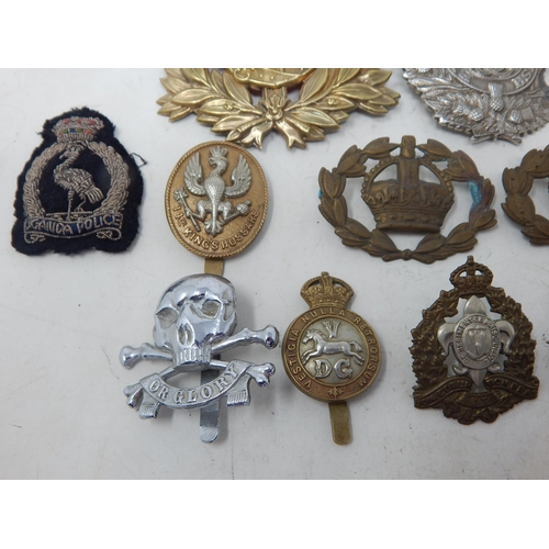 441 - A Quantity of Military Brass & White Metal Badges together with cloth badges & insignia.