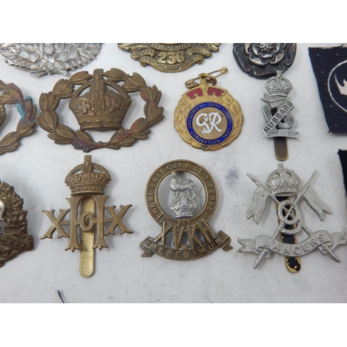 441 - A Quantity of Military Brass & White Metal Badges together with cloth badges & insignia.