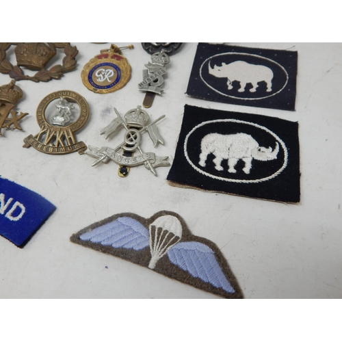 441 - A Quantity of Military Brass & White Metal Badges together with cloth badges & insignia.