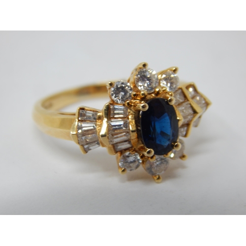 229 - 18ct Gold Diamond & Sapphire Set Ring: The Central Oval Cut Sapphire estimated @ 0.50cts within a bo... 