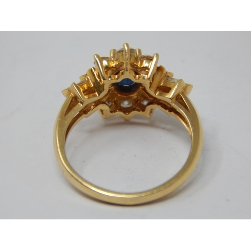 229 - 18ct Gold Diamond & Sapphire Set Ring: The Central Oval Cut Sapphire estimated @ 0.50cts within a bo... 