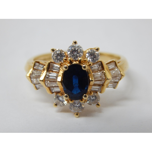 229 - 18ct Gold Diamond & Sapphire Set Ring: The Central Oval Cut Sapphire estimated @ 0.50cts within a bo... 