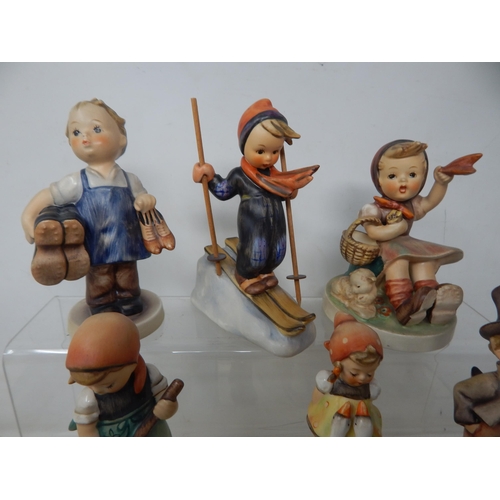 471 - A Quantity of Hummel Figures (9) together with a Hummel collectors guide and a set of Hummel place m... 