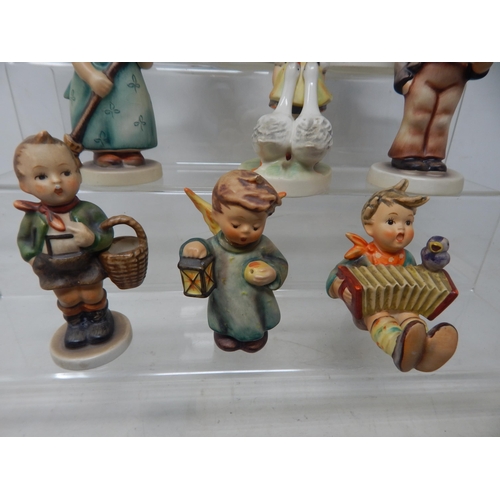 471 - A Quantity of Hummel Figures (9) together with a Hummel collectors guide and a set of Hummel place m... 