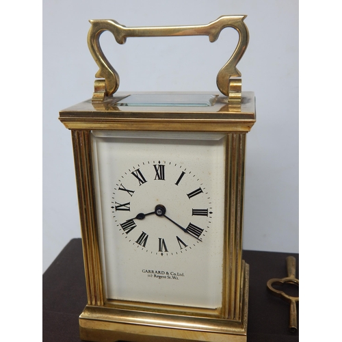 351 - Garrard & Co, Crown Jewellers, Brass Carriage Clock with fluted column decoration, complete with key... 