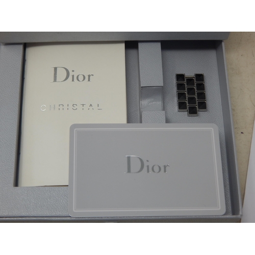 306 - Dior: A Christian Dior Christal diamond set bracelet watch, the black chronograph dial set with 14 r... 