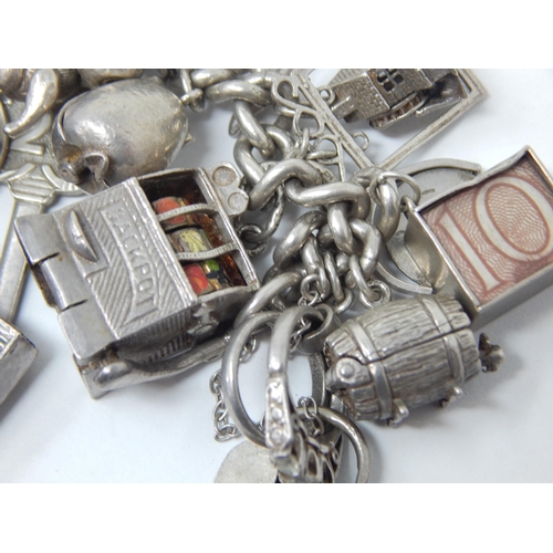 207 - Hallmarked Silver Charm Bracelet with Numerous Charms: Gross weight 134g